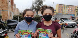 Girls with Zuri booklet from Plan International