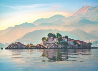 Sveti Stefan and mountains in Adriatic sea at sunset, Montenegro