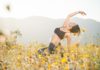 A young Hispanic women doing yoga in the desert during a spring bloom of wild flowers.