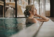 Sensual young woman relaxing in spa swimming pool