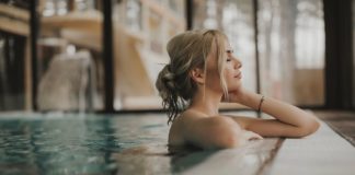 Sensual young woman relaxing in spa swimming pool