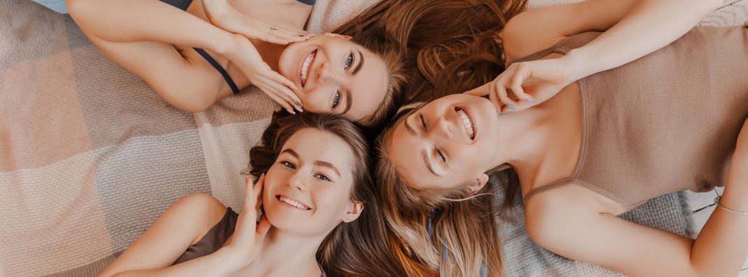 Women,Rest,And,Have,Fun.,Girlfriends,Laugh,At,Home,Lying