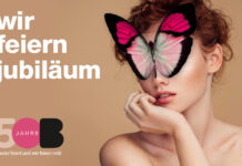Runder Geburtstag bei baslerbeauty Das Plakat zum 50jährigen Firmenjubiläum, zeigt Gesicht und Schultern einer jungen Frau. Mitten im Gesicht sitzt ein großer Schmetterlin, der ihre Augen und einen Teil der Stirn verdeckt.