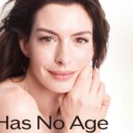 Frau blickt lächelnd in die Kamera, neben ihr stehen zwei Kosmetikprodukte von Shiseido