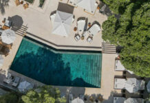 SLH führt Wellbeing Collection ein Luftbildaufnahme Hotelterasse mit Pool, Liegen und Sonnenschirmen
