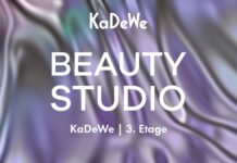 Kuratierte Erlebnis-Destination in Berlin Weißer Schriftzug KaDeWe Beauty Studio vor lia-grün gewirktem Hintergrund.